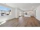 Open living room with wood floors, white walls, recessed lights and access to the kitchen at 1331 Rock Cliff Ave, Erie, CO 80516