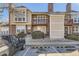 Charming multi-level townhome featuring brick accents, a cozy balcony, and well-maintained landscaping at 1100 S Waco St # D, Aurora, CO 80017