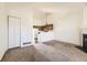 Open floor plan featuring carpeted floors, a fireplace, and kitchen view at 1100 S Waco St # D, Aurora, CO 80017