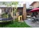 Backyard featuring a dog house, covered outdoor seating, and a trampoline at 1143 S Saint Paul St, Denver, CO 80210