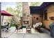 Cozy backyard patio with an outdoor fireplace and comfortable wicker furniture at 1143 S Saint Paul St, Denver, CO 80210