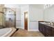 Elegant bathroom featuring a glass shower, soaking tub, and stylish vanity with granite countertop at 1143 S Saint Paul St, Denver, CO 80210