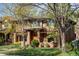 Beautiful two-story brick home with a covered porch, manicured lawn and mature trees at 1143 S Saint Paul St, Denver, CO 80210