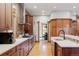 Spacious kitchen showcasing wood cabinets, stainless steel hood, and an eat-in kitchen at 1143 S Saint Paul St, Denver, CO 80210