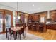 Spacious kitchen with wooden cabinets, a central island with seating and a dining area at 1143 S Saint Paul St, Denver, CO 80210