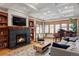 Elegant living room with a fireplace, large windows, piano and coffered ceiling at 1143 S Saint Paul St, Denver, CO 80210