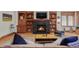 Inviting living room featuring a fireplace, built-in bookshelves and hardwood floors at 1143 S Saint Paul St, Denver, CO 80210
