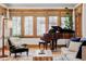 Bright living room featuring a piano, hardwood floors, and natural light streaming through the windows at 1143 S Saint Paul St, Denver, CO 80210