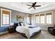 A large main bedroom featuring a decorative ceiling fan, a comfy bed, and ambient lighting at 1143 S Saint Paul St, Denver, CO 80210