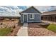 The backyard features a patio, turf and gravel landscaping, as well as a small detached dwelling at 55490 E 27Th Pl, Strasburg, CO 80136