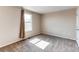 This bedroom features plush carpeting, a window with natural light, and neutral paint colors at 55490 E 27Th Pl, Strasburg, CO 80136