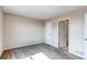 Neutral bedroom with carpet, featuring a bathroom with a shower-tub combo at 55490 E 27Th Pl, Strasburg, CO 80136