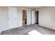 Cozy bedroom with neutral carpet, featuring a bathroom with a shower-tub combo at 55490 E 27Th Pl, Strasburg, CO 80136