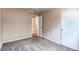 This bedroom features neutral paint, soft carpeting, and an closet with an open doorway at 55490 E 27Th Pl, Strasburg, CO 80136