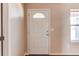 Interior view of the white front door with window, adjacent to a light-colored wall at 55490 E 27Th Pl, Strasburg, CO 80136