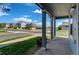 View from the covered porch towards the street, showcasing the neighborhood at 55490 E 27Th Pl, Strasburg, CO 80136