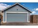 Detached garage featuring a single car garage door with horizontal panels and the address number '55490' at 55490 E 27Th Pl, Strasburg, CO 80136