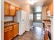 This kitchen boasts tile floors, wooden cabinets, and modern white appliances at 55490 E 27Th Pl, Strasburg, CO 80136