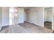 Spacious carpeted living room with access to hallways and other rooms at 55490 E 27Th Pl, Strasburg, CO 80136