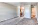 View from the living room showcasing the kitchen and a bathroom area at 55490 E 27Th Pl, Strasburg, CO 80136