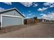 Detached garage at the end of a long driveway with address number '55490' and a peek at surrounding neighborhood at 55490 E 27Th Pl, Strasburg, CO 80136