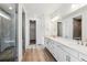 Modern bathroom with double vanity, quartz countertops, and a glass-enclosed shower at 39161 Anthony St, Elizabeth, CO 80107