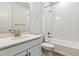 Spotless bathroom features a shower and tub combination, a brushed nickel faucet and all white tiling at 39161 Anthony St, Elizabeth, CO 80107
