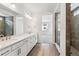 Contemporary bathroom featuring double vanity, stone flooring, and glass shower enclosure at 39161 Anthony St, Elizabeth, CO 80107