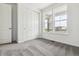 Bright bedroom features neutral carpet, a large window with views, and a closet with sliding doors at 39161 Anthony St, Elizabeth, CO 80107