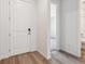 Hallway view showcases new wood flooring and flows to a room and full bathroom at 39161 Anthony St, Elizabeth, CO 80107