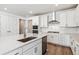Bright white kitchen features stainless appliances, modern fixtures, and hardwood flooring at 39161 Anthony St, Elizabeth, CO 80107