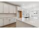 Modern kitchen includes stainless sink, quartz countertops, white cabinets and hardwood floors at 39161 Anthony St, Elizabeth, CO 80107