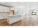 Open-concept kitchen with white cabinets, quartz countertops, and stainless steel appliances at 39161 Anthony St, Elizabeth, CO 80107