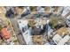 Aerial view of a home with a dark roof, surrounded by trees, neighboring homes, and snowy streets at 5121 W Plymouth Dr, Littleton, CO 80128