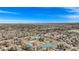 Expansive aerial view of a neighborhood showcasing houses, schools, and greenery against a clear blue sky at 5121 W Plymouth Dr, Littleton, CO 80128