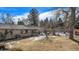 Spacious backyard featuring a well-maintained lawn, patio area, and mature trees at 5121 W Plymouth Dr, Littleton, CO 80128