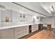 Modern basement bar with light cabinets, quartz countertops and a stylish wine rack at 5121 W Plymouth Dr, Littleton, CO 80128