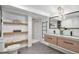 Modern bathroom with double vanity, a walk-in shower, and floating shelves for ample storage at 5121 W Plymouth Dr, Littleton, CO 80128