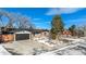 Charming single-story home with a brick facade, a two-car garage, and snow on the front lawn at 5121 W Plymouth Dr, Littleton, CO 80128