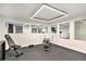 Home gym with mirrors, free weights and rubberized flooring at 5121 W Plymouth Dr, Littleton, CO 80128