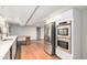 Modern kitchen with stainless steel appliances and wooden floors at 5121 W Plymouth Dr, Littleton, CO 80128