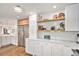 Modern kitchen featuring stainless steel appliances, marble counters and adjacent dining area at 5121 W Plymouth Dr, Littleton, CO 80128