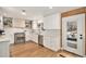 Bright kitchen with stainless steel appliances, white cabinets, and wood floors at 5121 W Plymouth Dr, Littleton, CO 80128