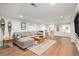 Basement living room with a comfortable sectional sofa, a natural-fiber area rug, and wood-look floors at 5121 W Plymouth Dr, Littleton, CO 80128