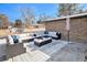 Relaxing outdoor patio featuring a large sectional sofa, ottoman, and an outdoor rug at 5121 W Plymouth Dr, Littleton, CO 80128