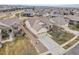 Aerial view of a charming, tan single-Gathering home with well-manicured landscaping and a two-car garage at 4280 Crystal Dr, Broomfield, CO 80023