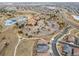 Aerial view showcasing a community clubhouse, a winding road, and nearby neighborhoods at 4280 Crystal Dr, Broomfield, CO 80023