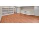 Spacious finished basement with hardwood floors and built-in shelving units at 4280 Crystal Dr, Broomfield, CO 80023