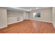 Finished basement with hardwood floors, a large open area and a window for natural light at 4280 Crystal Dr, Broomfield, CO 80023