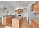 Island kitchen with granite countertops and hardwood floors at 4280 Crystal Dr, Broomfield, CO 80023